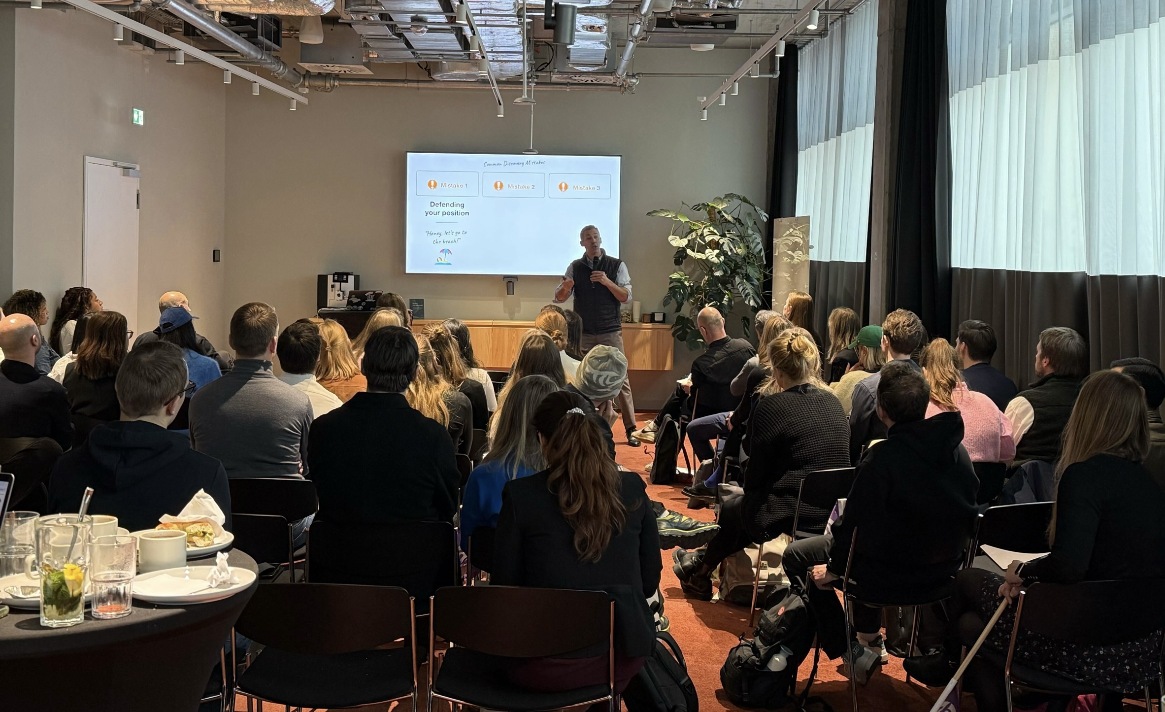 David presenting to a large seated audience