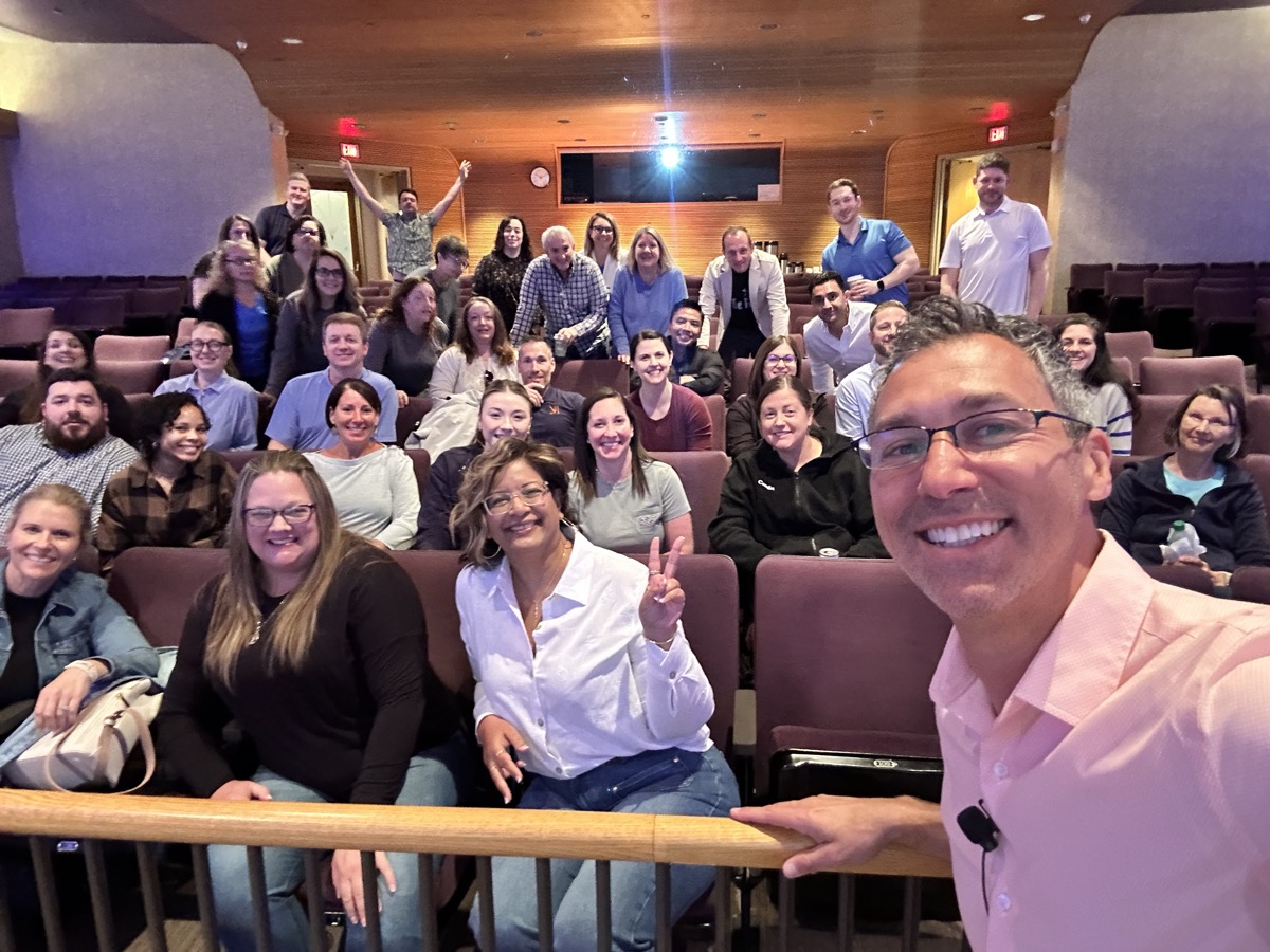 Group selfie with workshop participants in an auditorium